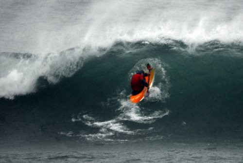 Surf Kayak breaking out through the surf, paddle out technique
